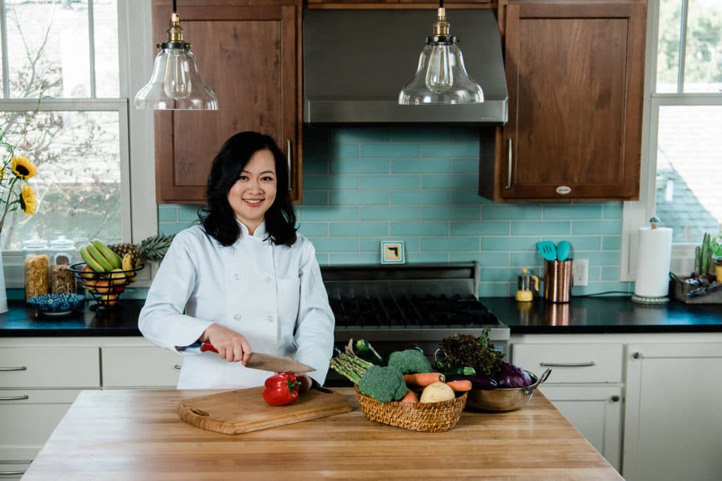 personal chef branding photos in kitchen cutting veggies