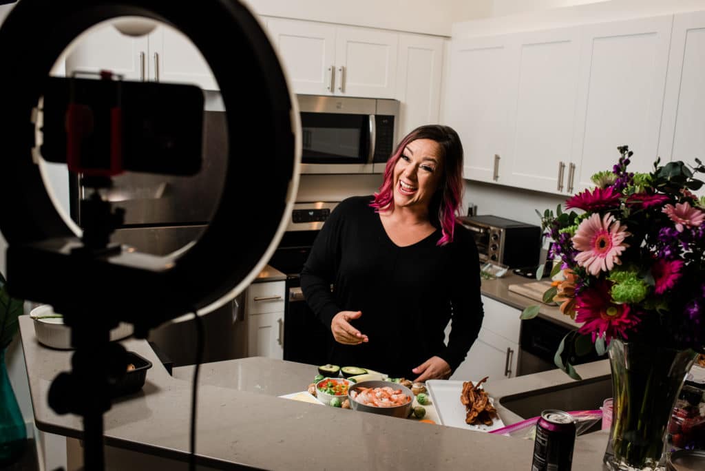 woman in kitchen creating content on video