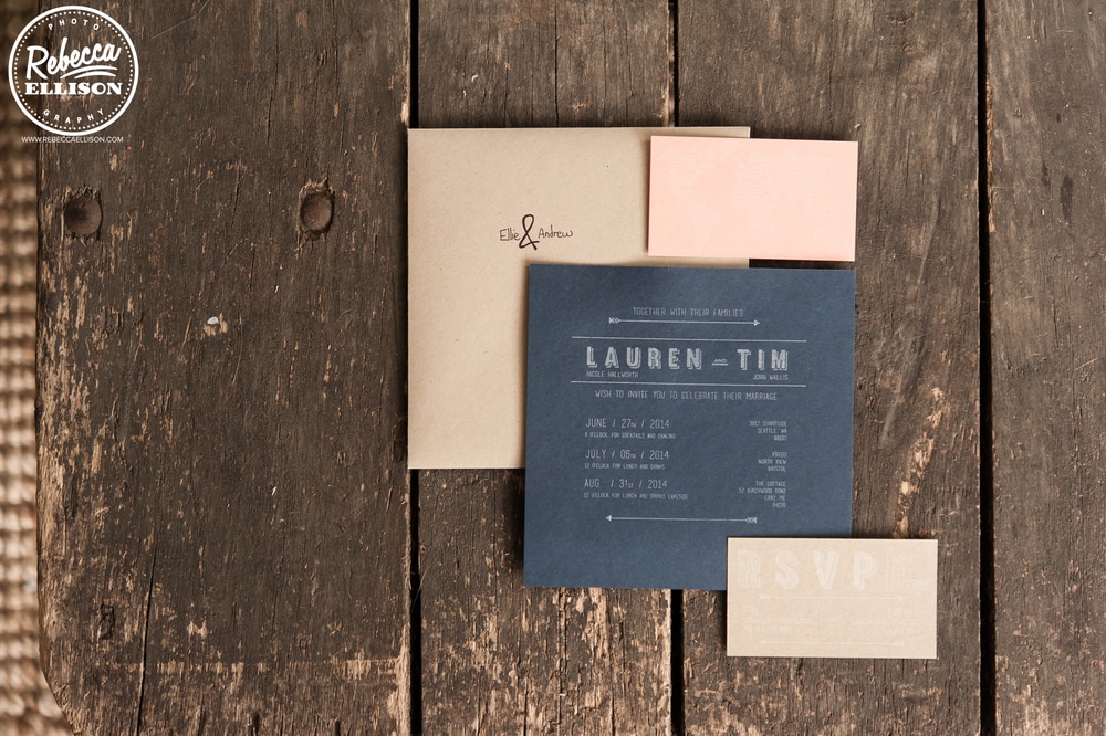 Black wedding invitations against a wooden background photographed by Seattle wedding photographer Rebecca Ellison