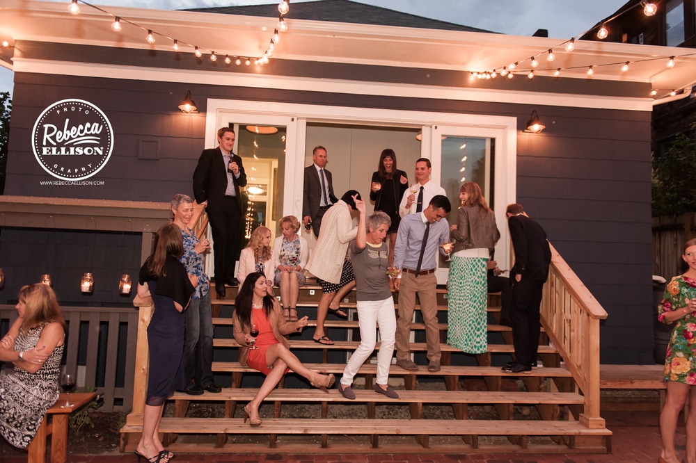 Wedding guests enjoy the reception at an intimate backyard wedding in Seattle photographed by Rebecca Ellison photography