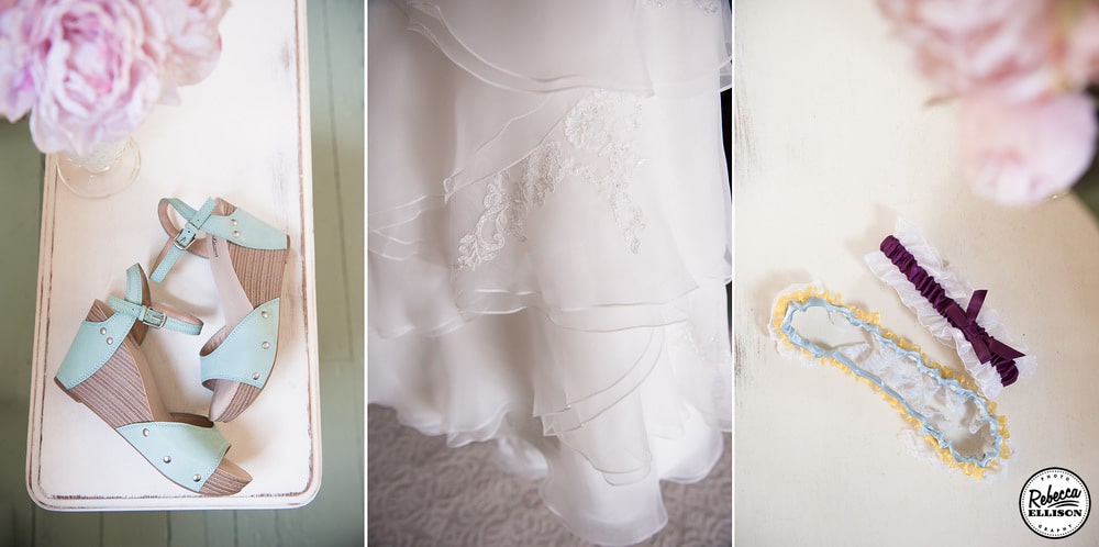 Bridal details light blue wedge sandals, a layered lace skirt and lace garter on top of a vintage table photographed by Rebecca Ellison photography