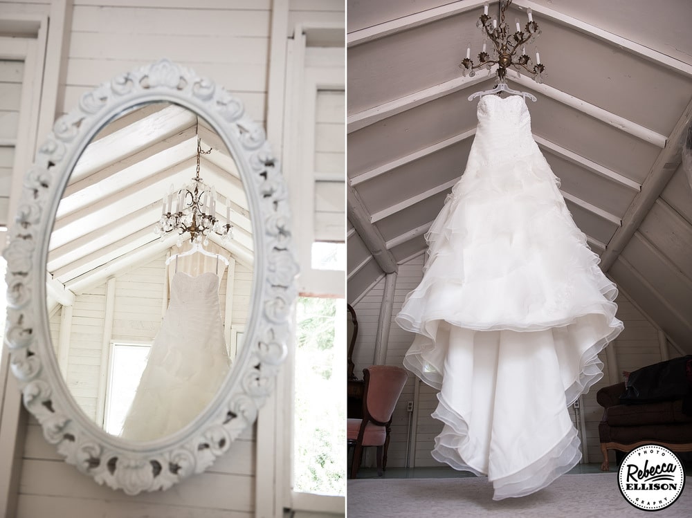 Bridal Details wedding dress hangs from a vintage chandelier and the reflection is shown in an antique mirror photographed by Seattle wedding photographer Rebecca Ellison