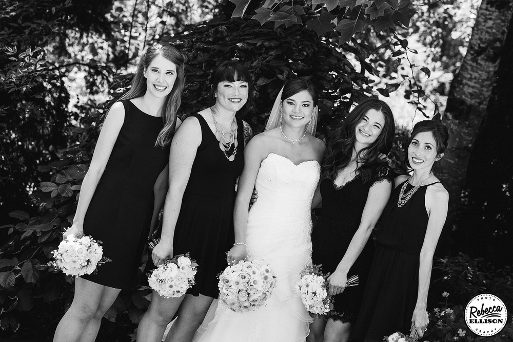 Black and white outdoor bridal party portraits featuring black bridesmaids dresses photographed by Rebecca Ellison Photography