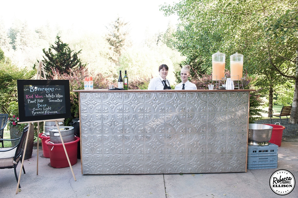 Hammered metal and chalkboard bar menu at an outdoor garden wedding