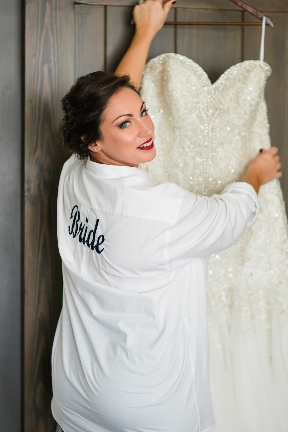 Bride getting dressed at Hotel Ballard before their fremont Foundry wedding