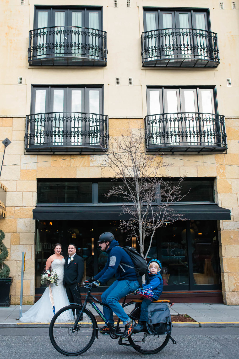 biker with kid in wedding photos outside of Hotel Ballard