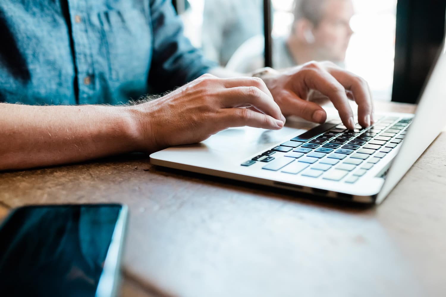 man typing on computer. 10 reasons why blogging is important to your small business in 2019